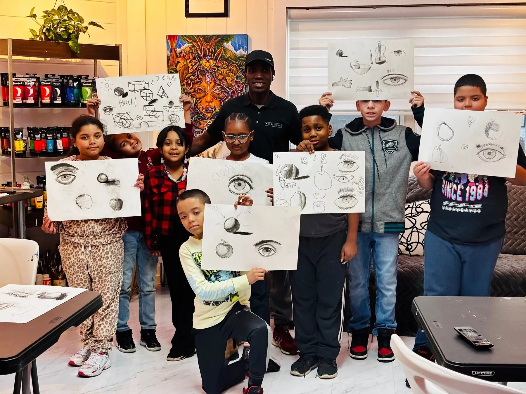 Young artists showing their drawings